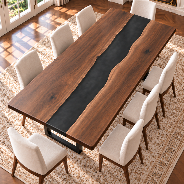 High-angle view of two walnut slabs and a gently winding black resin river.