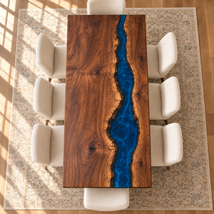 Overhead view of the Rivercrest dining table showing walnut grain and an offset blue epoxy river.