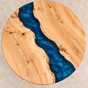 Overhead view of the circular ash surface and winding blue epoxy river.