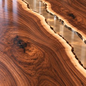 Close-up of walnut grain, a natural knot, pale sapwood and the clear epoxy boundary.
