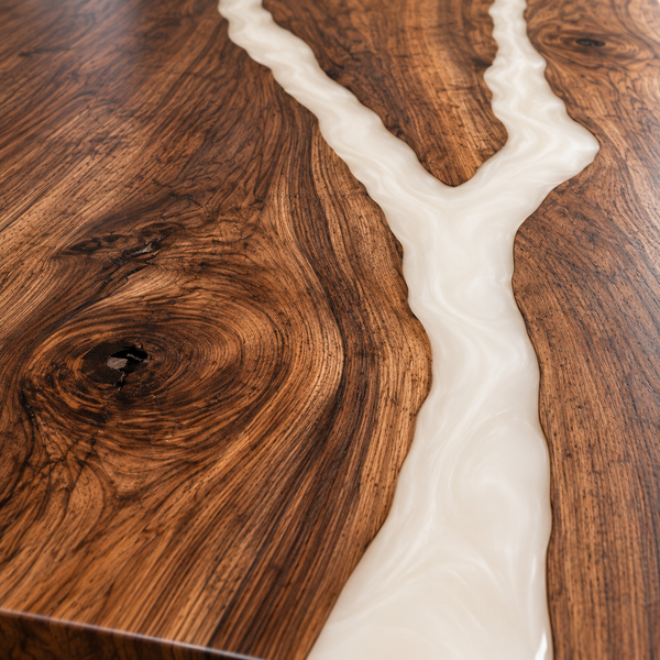 Wood grain and resin detail of the Ivorybranch rectangular walnut dining table with white epoxy.